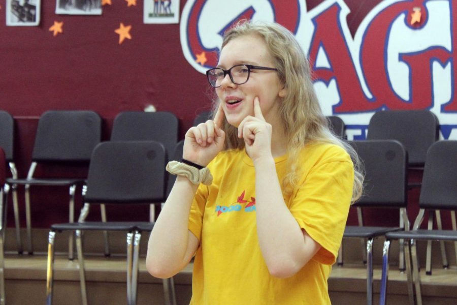 Sophomore Phoebe McKinney sings and dances during her zero hour choir class. Choir is preparing for their 1940s POPS concert May 29 in the High School auditorium . 