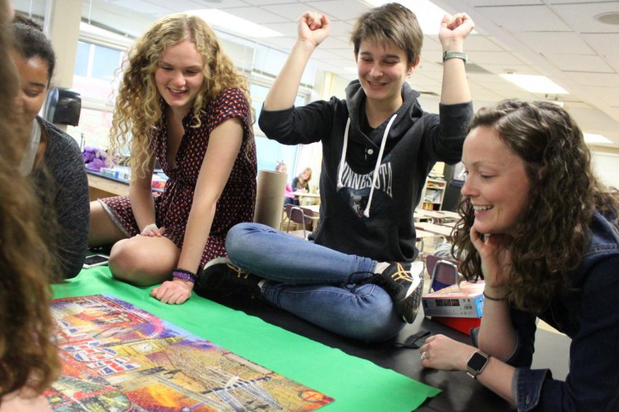 Senior Greta Long rejoices after placing the last piece in the puzzle at puzzle club May 23. Puzzle clubs leaders are seniors, and do not have a plan for next year, according to Long. 