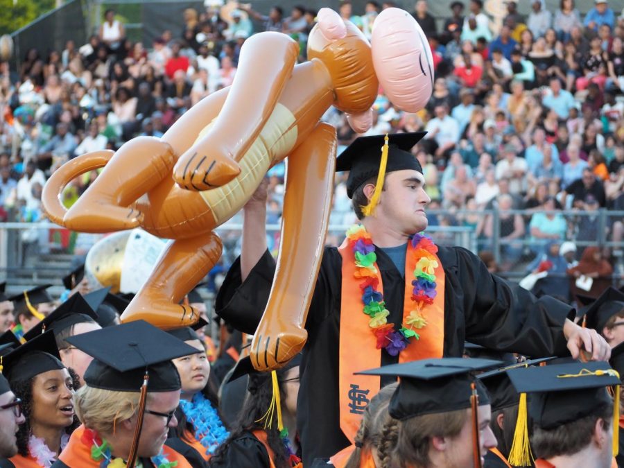 Graduate John Meyer throws an inflatable at his classmate between speeches. Before graduating June 6, students played with bubbles and inflatables. 