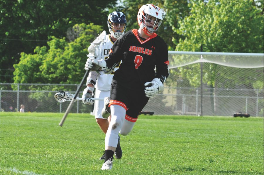 Junior Flynn Spano cradles the ball with his stick while running the ball toward the opponents goal. 
The score of Parks final game of the season against Totino-Grace was 0-14.