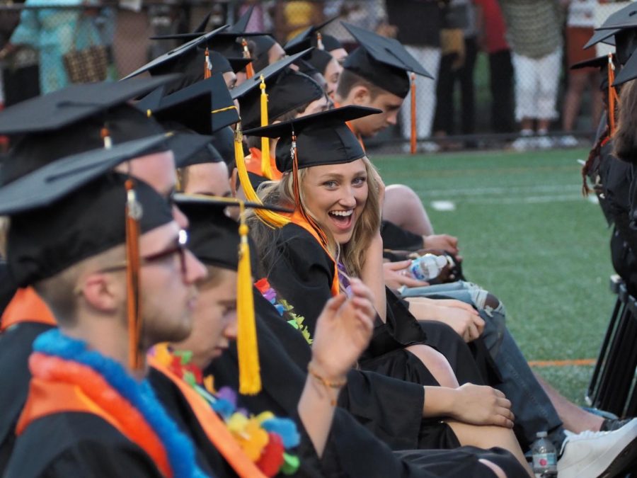 Grace Lynch smiles in between Valedictorian speeches in light of the upbeat mood at Graduation. 