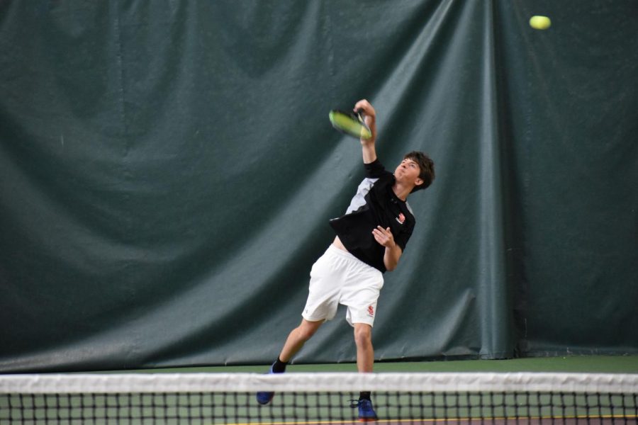 Working hard to win the match point, Sophomore Johnny Falzone smacks the ball to his opponent. Him and his partner Gerald Perelman played against Apple Valley. 