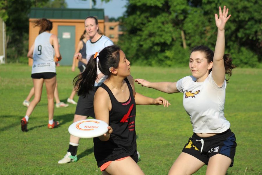 Senior Anna Kasper flicks the disc to her teammate June 5 at Oak Hill Park. The Park ultimate boys and girls teams played the coaches and alum during this end of the year team bonding game.