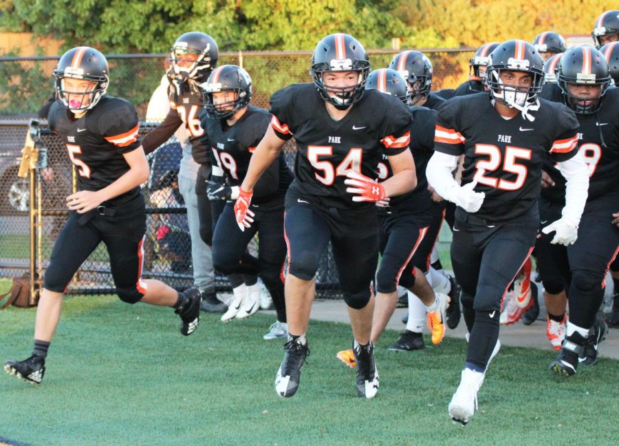 The football team runs onto field in their first home game of the 2018 season. The  first home game of the 2019 season will be Aug. 29 at the Oriole Stadium.