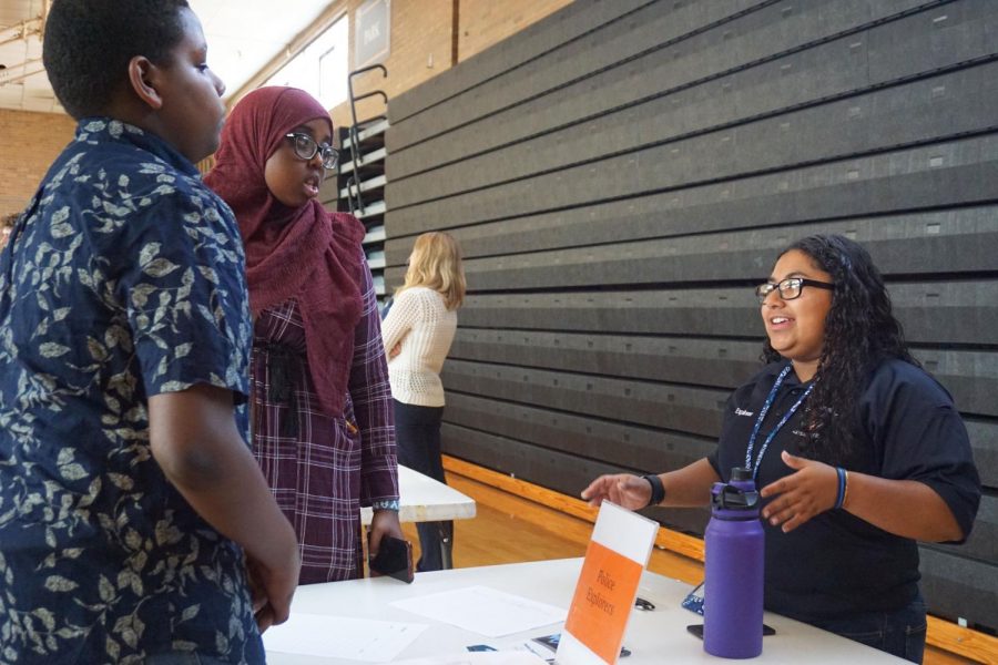 Junior Isela Perez-Kauhaihao talks with incoming freshmen about her experience on the Police Explorers. This program is one of the many students could learn about during the activities fair Aug. 28.