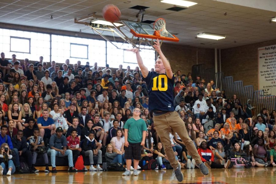 Senior Colin Weingart attempts the half court shot during the Pep fest the first day of school. The event also included a dance performance from the teachers and a sibling relay race.