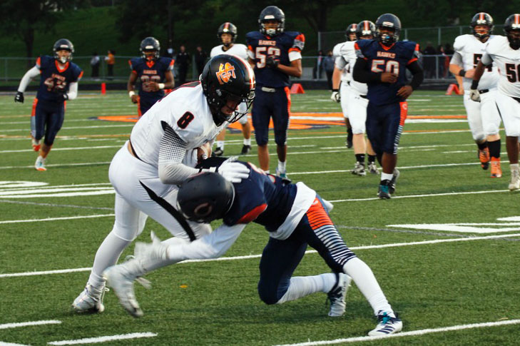 Junior McCabe Dvorak fights against a defending players tackle. This was the football teams third game this season. Its next game will be at 7 p.m. Sept. 20 at the stadium. 