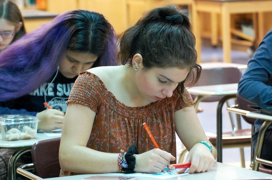 Freshman Amalia Fischer draws on a coloring sheet hand out during the first Intersectional Feminism Club meeting of the year. The club met Sept. 12 to collaborate on its goals for the year.