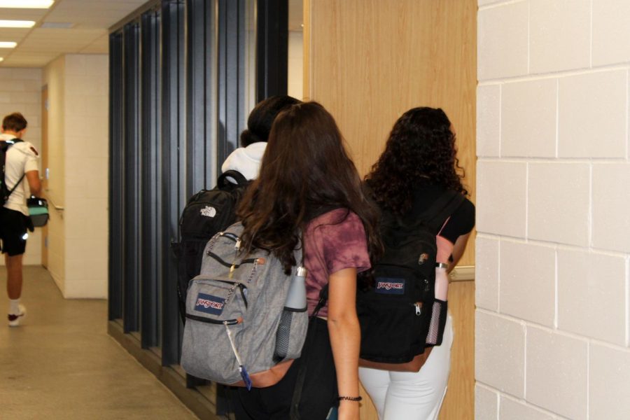 Students enter the locker room to drop off sports equipment Sept. 20. Students are now able to enter the locker room 10 minutes before school starts. 