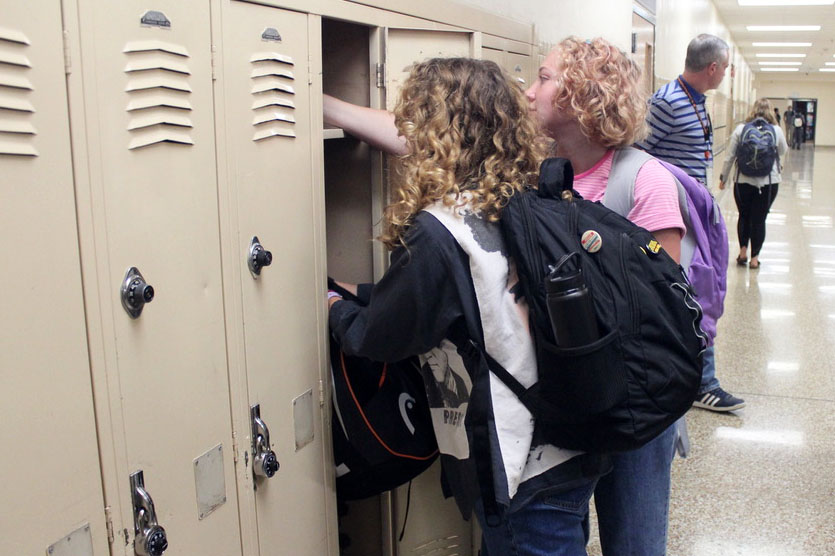 Junior Evie Gutzke and freshman Coco Gutzke put their sports gear in regular school lockers the morning of Sept. 18. As of Sept. 23, the new policy allows students to put their equipment in the locker rooms before school.