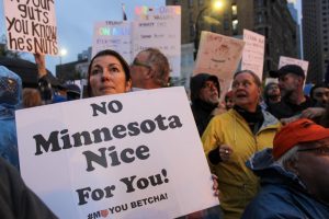 Protesters from anti-Trump rally express unwelcoming feelings towards President Trumps visit to Minneapolis.