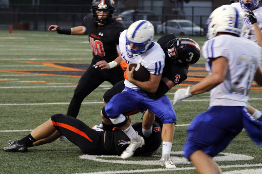 Senior Cole Ewald tackles a defending player for possession of the football. Park fell to Spring Lake Park, leaving the team with a 1-3 record as of Sept. 20.