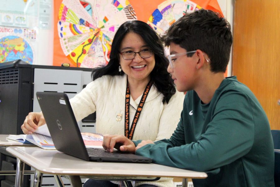 Spanish teacher Nelly Korman assists freshman Solin Mendes-Duffy with an assignment Oct. 24. Korman is running for Bloomington school board for the 2019 election. 
