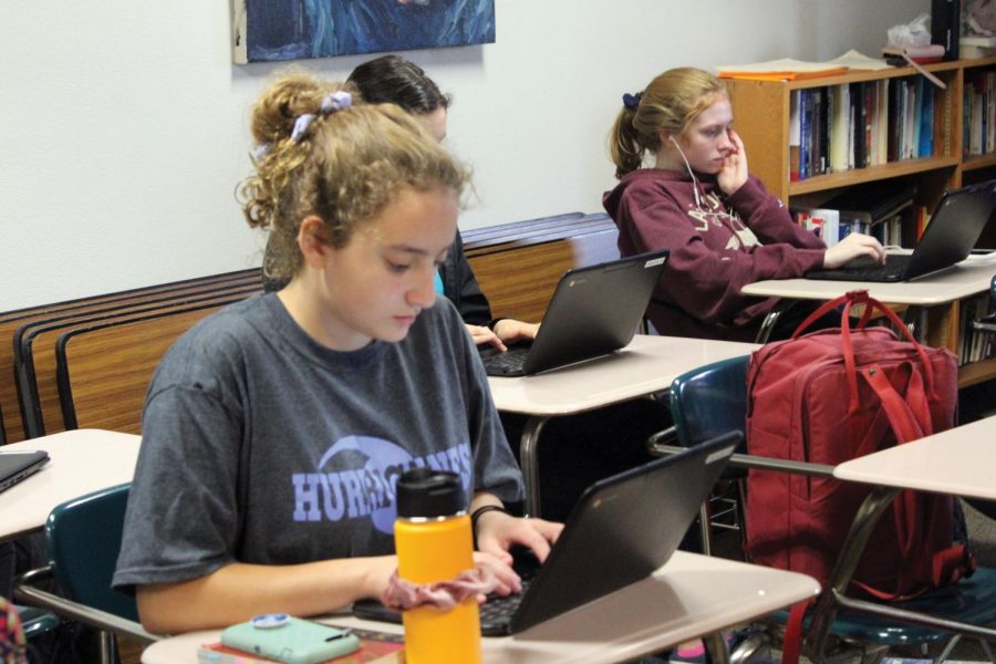 Juniors Julia Salita and Liz Madigan work on an online assignment in English teacher Andrew Wilkess class Oct. 3. Wilkes works to go paperless this school year.