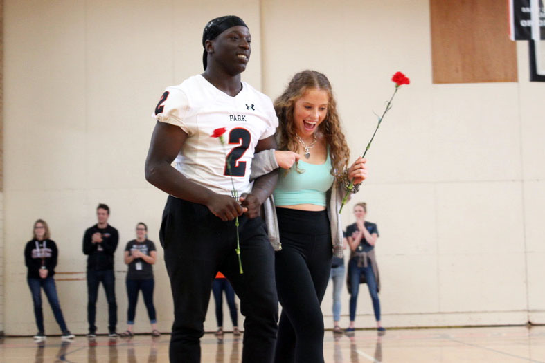 Senior Tobyous Davenport gets escorted by junior Katie Casey Sept. 13 at the pep fest. Davenport was chosen by the senior class to be in the Homecoming court.