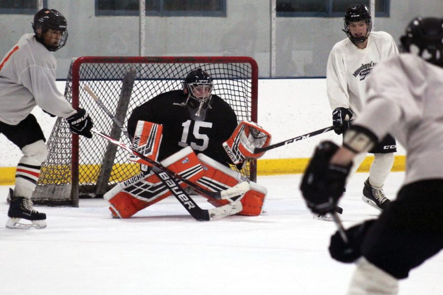 Senior Will Pinney blocks a shot on goal during a shooting drill at practice Sept. 23. For every shot Pinney blocks during his hockey games, he raises money to help women dealing with breast cancer.