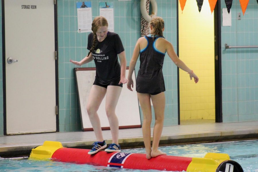Freshmen Christina Loschy and Molly Horstman-Olson practice their log rolling technique Nov. 6 at the Central pool. Participants learned the basics of log rolling and had the chance to log roll with a partner. 