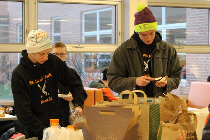 Juniors Max Gohman and Benn Katzovitz grab breakfast before going out to fundraise. The Nordic team knocked on neighborhood doors to sell coupon books Nov. 23.