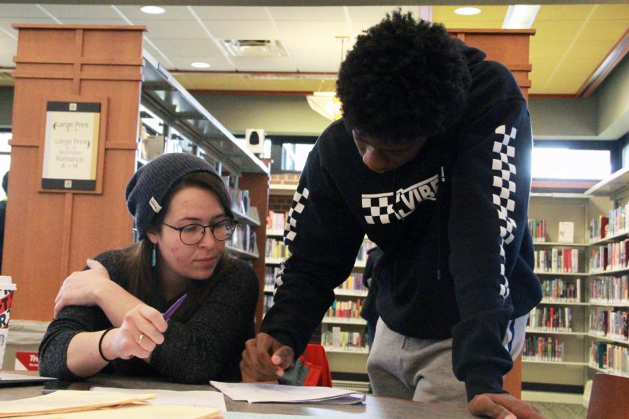 Math teacher Meredith Webster helps junior Denzel Thomas at the St. Louis Park Library Nov. 16. Park teachers are offering their time to tutor students 9 a.m. to noon every Saturday.