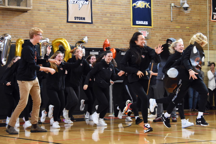 Park’s volleyball team runs through a “Go Park VBall” banner. The pep fest Nov. 6 was held in celebration of Park volleyball’s first State qualification.