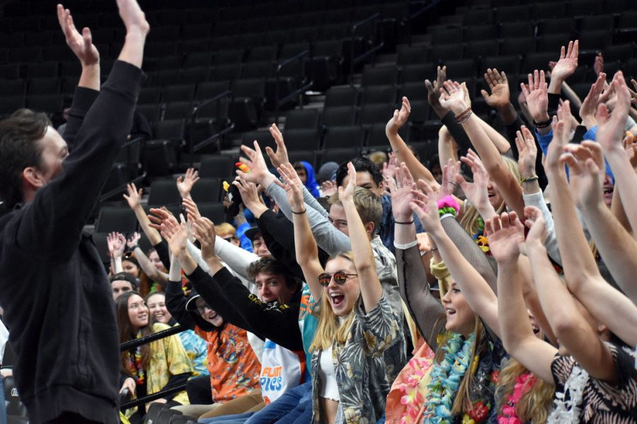 Math teacher Robert Otto leads the cheer at the State volleyball tournament against Moorhead Nov. 8. According to the School Board students and administration should give more attention and enthusiasm to other clubs and activities. 