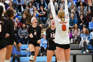 The girls volleyball team celebrates after scoring a point in the varsity Sections match against Bloomington Jefferson Nov. 2. Park won the match 3-2.