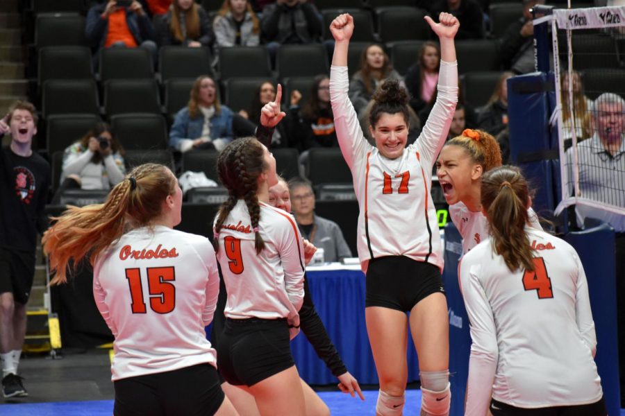 Juniors Hannah Howell and Kendall Coley rejoice after scoring a point against Moorhead. According to assistant principal Jessica Busse, nine buses transported students to the Xcel Energy Center Nov. 8.