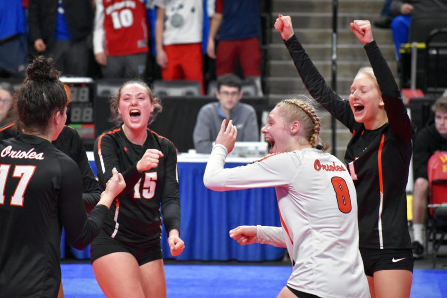 Seniors Makaila Winward, Addie Warg and junior Maya Betzer celebrate after scoring a point against Eagan. The State tournament is taking place at the Xcel Energy Center Nov. 7-9.