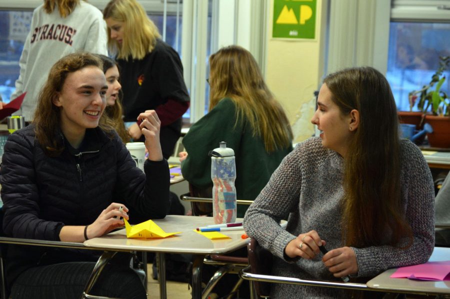 Junior Elizabeth Orton and junior Kathryn Schug collaborate while making cards. Feminism Club and Letters of Love combine meetings to gain engagement. 