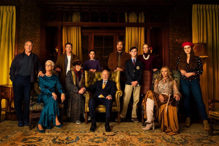 Fair use from Lionsgate Films: The Thrombey family poses with their patriarch and famed mystery author, Harlan Thrombey. Soon the family would be divided by the conditions of Harlans death.