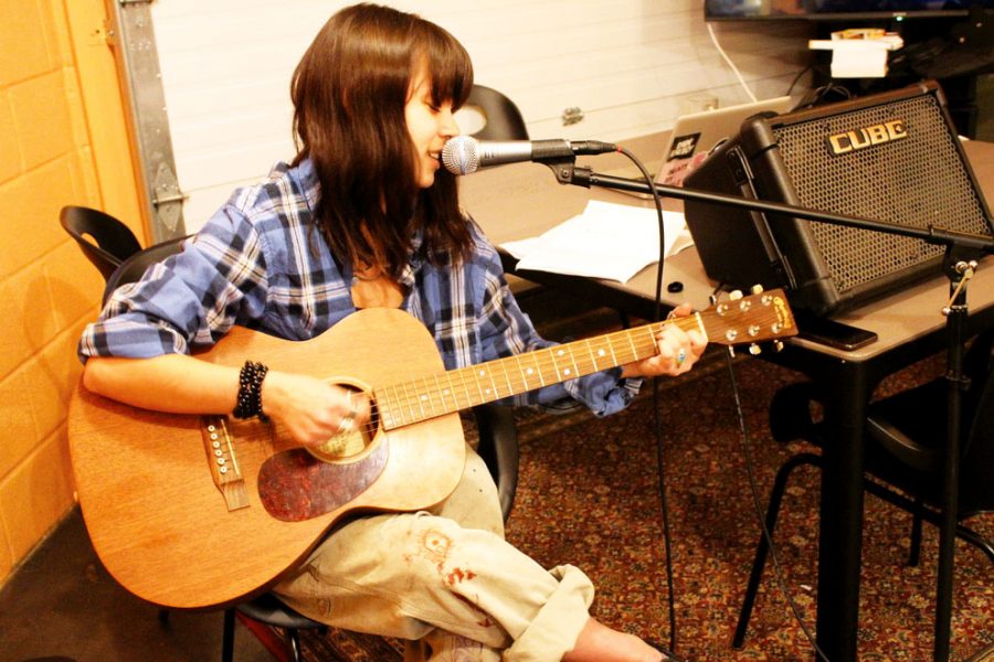 Sophomore Anna Overall plays guitar for open mic event at the Nest Nov. 26.