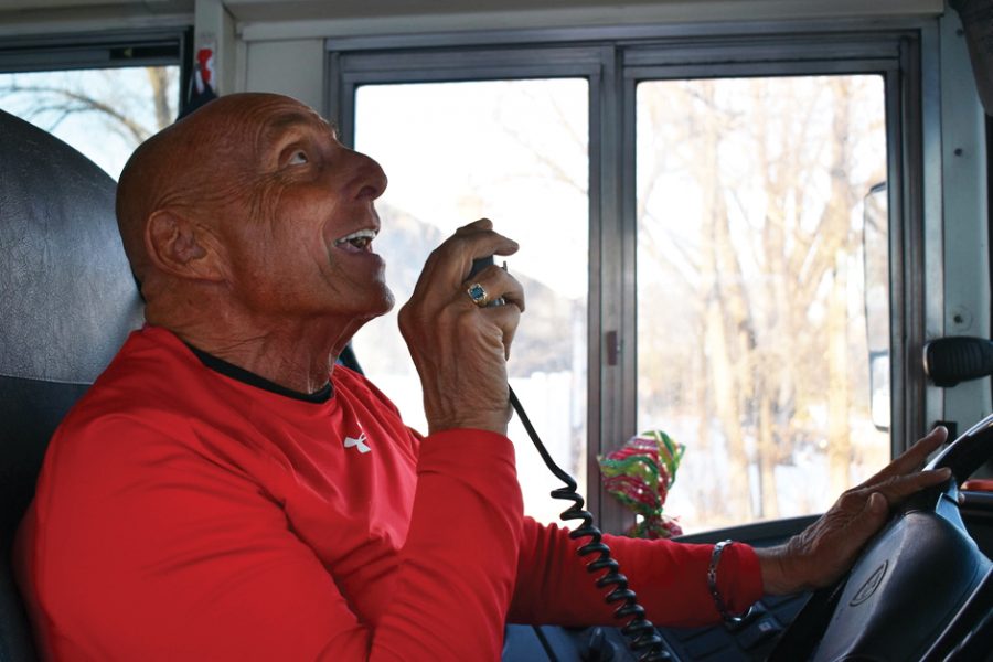 Bus driver Jay Wolkenbrod sings Happy Birthday to a student Dec. 20. Wolkenbrod celebrates birthdays and brings gifts, including a balloon and a card, to students.