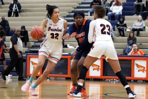 Juniors Kendall Coley and Raegan Alexander to block Robbinsdale Cooper defender junior Meme Wheeler Jan 3. Park lost to Robbinsdale Cooper 62-69. At one point during the second half, the team was down by two points.