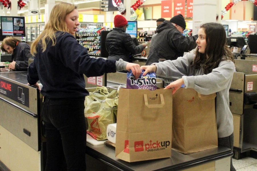 Echowan members and juniors Casey Hunter and Rachel Stein bag a customers groceries Jan 19 at Cub Foods for an Echowan fundraiser. Echowan will be taking club photos Feb. 13 in the old gym.