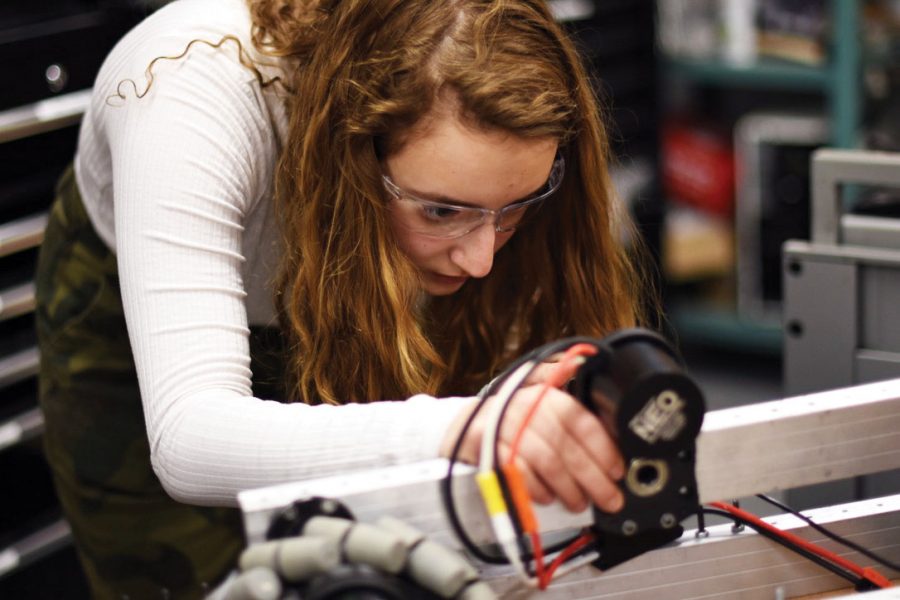 Junior Julia Salita works on a robot during robotics practice Feb. 10. Salita said the team is currently strategizing before working on the robot for competition. 