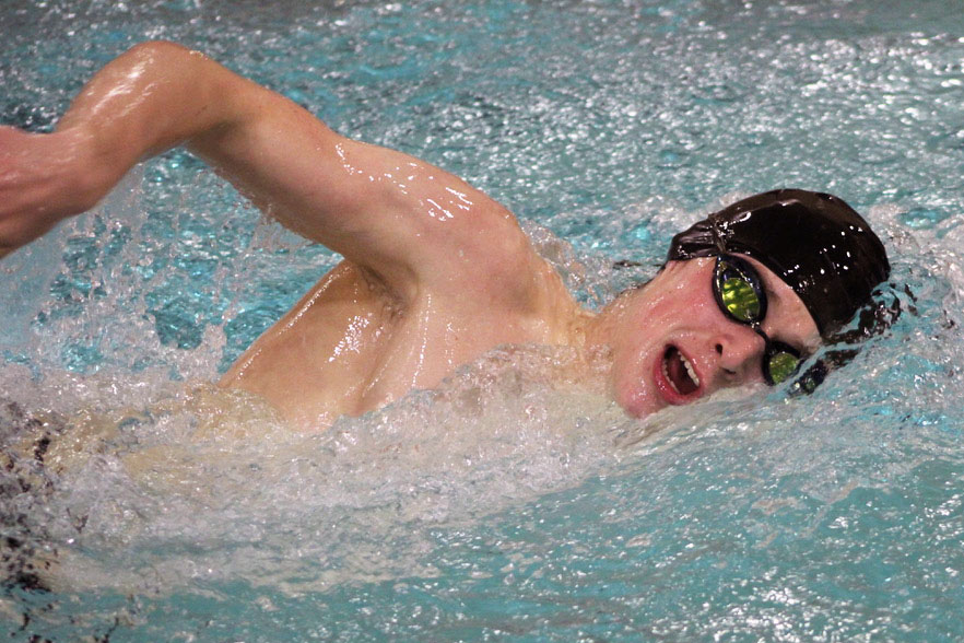 Junior Ben St. Clair practices freestyle during practice Feb. 19. St. Clair first began swimming several years ago after a series of injuries in other sports.
