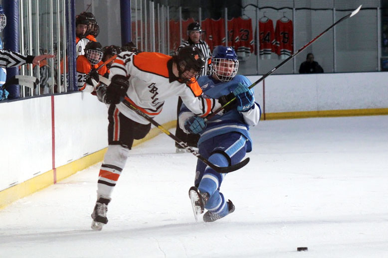 Senior Bobby Doss shoves Bloomington Jefferson’s junior Pierce Thomka while reaching for the puck. Park finished the regular season with an overall record of 16-9-0. 