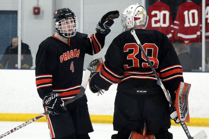 Seniors Jamie Sorenson and William Pinney high five in celebration after a save. Pinney had a 0.925 save percentage during the game against Benilde-St. Margaret’s.