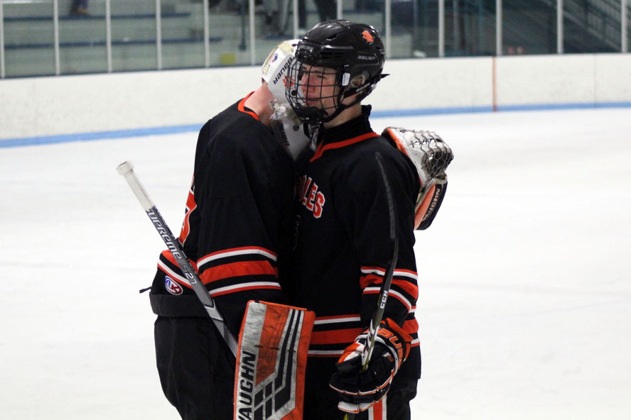 Seniors Jacob Johnson and William Pinney embrace each other following the Feb. 20 Sections loss against Cretin-Durham Hall. The final score of the game was 3-6.