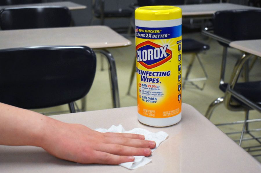Photo illustration by Kaia Myers. A desk is sanitized with a Clorox disinfecting wipe March 11. Park purchased many sanitizing  products, soap and tissues to help prevent the spread of COVID-19. 