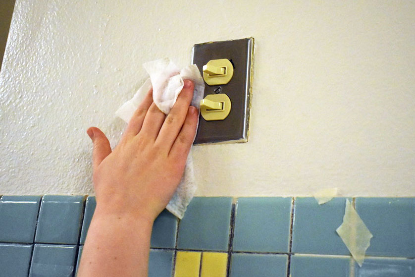 Photo illustration by Kaia Myers. A light switch is disinfected March 10.