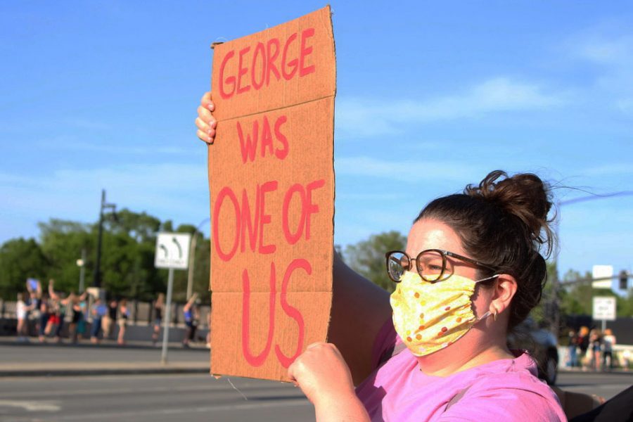 An attendee holds a sign saying George was one of us. According to the the New York Times, George Floyd was a St. Louis Park resident.