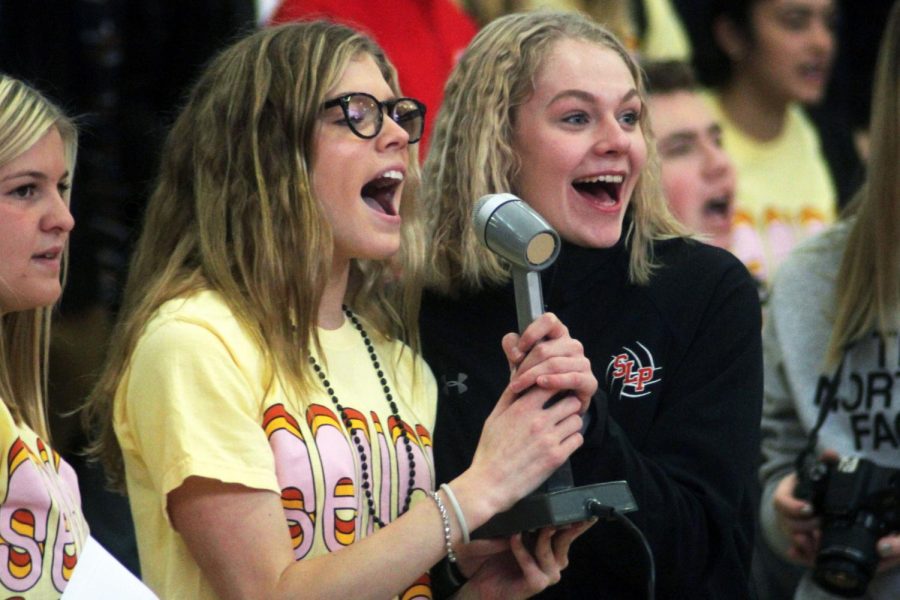 Seniors Hattie Kugler and Addie Warg speak to students during the Pep fest prior to the game Nov. 6. Each member of the volleyball team was introduced and cheered on by the school the day leading up to the game. 