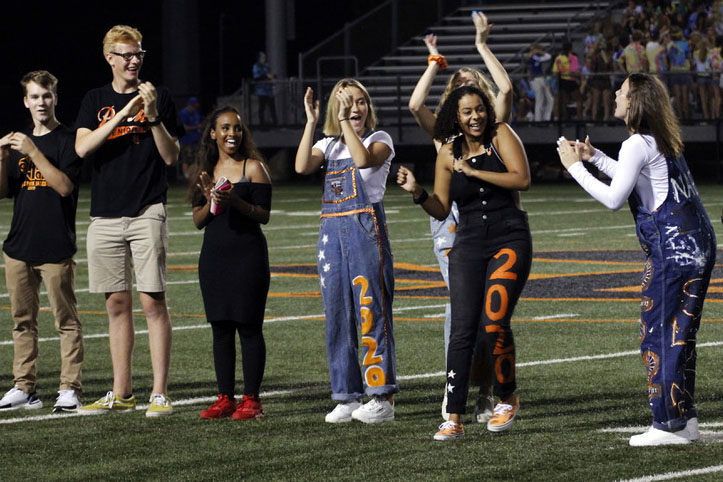 Homecoming court members cheer for senior Alyscia Thomas at the Homecoming football game Sept. 20. The Homecoming court was celebrated by Park football fans during halftime.