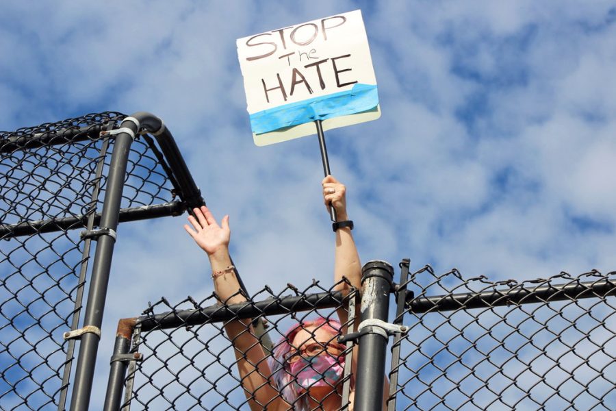 A protestor holds up a sign with the words “Stop The Hate.” Protestors were encouraged to wear masks and maintain social distancing while protesting.