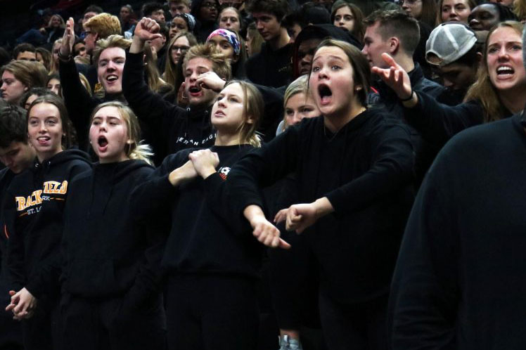 Seniors Ava Bishop, Sarah McCallon, Emma Roloff and Sydney Ring yell after the referee makes a call against Park Nov. 7. The dress code for the first round of the volleyball State competition was blackout. 