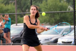 Junior Raquel Schlichting uses a backhand motion to hit the ball to her opponent Aug. 26. Park lost all of their varsity matches to Benilde-St. Margarets.