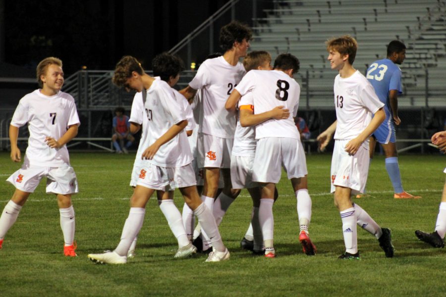 Sophomore captain Tommy Kniser celebrates with his teammates after he scores the second goal of the game. Park won their first conference game against Bloomington Jefferson 3-0. 
