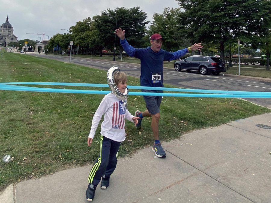 Social studies teacher Jeffrey Cohen runs across the finish line of his virtual Boston Marathon race Sep 7. Cohen decided to run the marathon virtually after it got cancelled earlier this year.