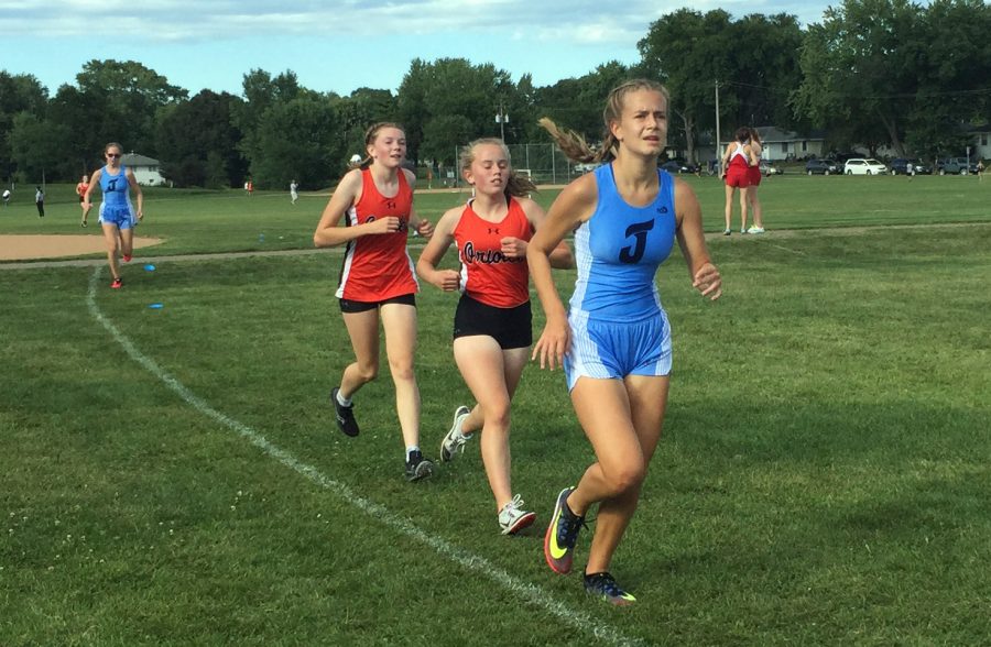 Eight graders Sela Myers and Nora Lindman run alongside a Bloomington Jefferson runner Sept. 4. Park began their season by hosting their first home meet in 20 years.